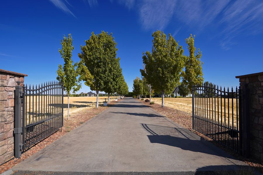 Gated entry and tree-lined drive at 182 Fountain Hills