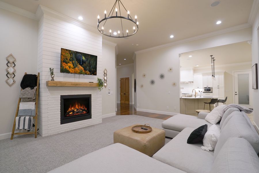 Great room with shiplap fireplace and valley view windows