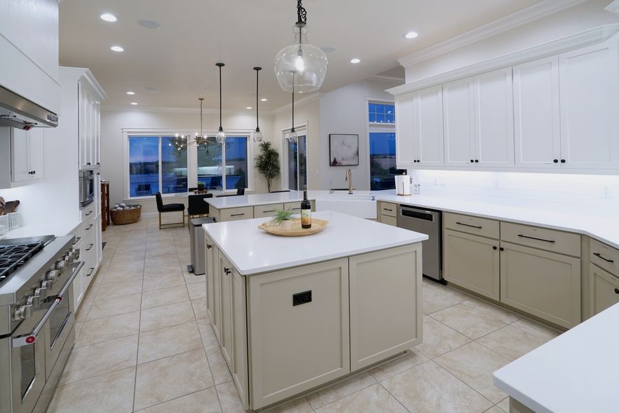 Chef's kitchen with quartz island, professional gas range and double ovens